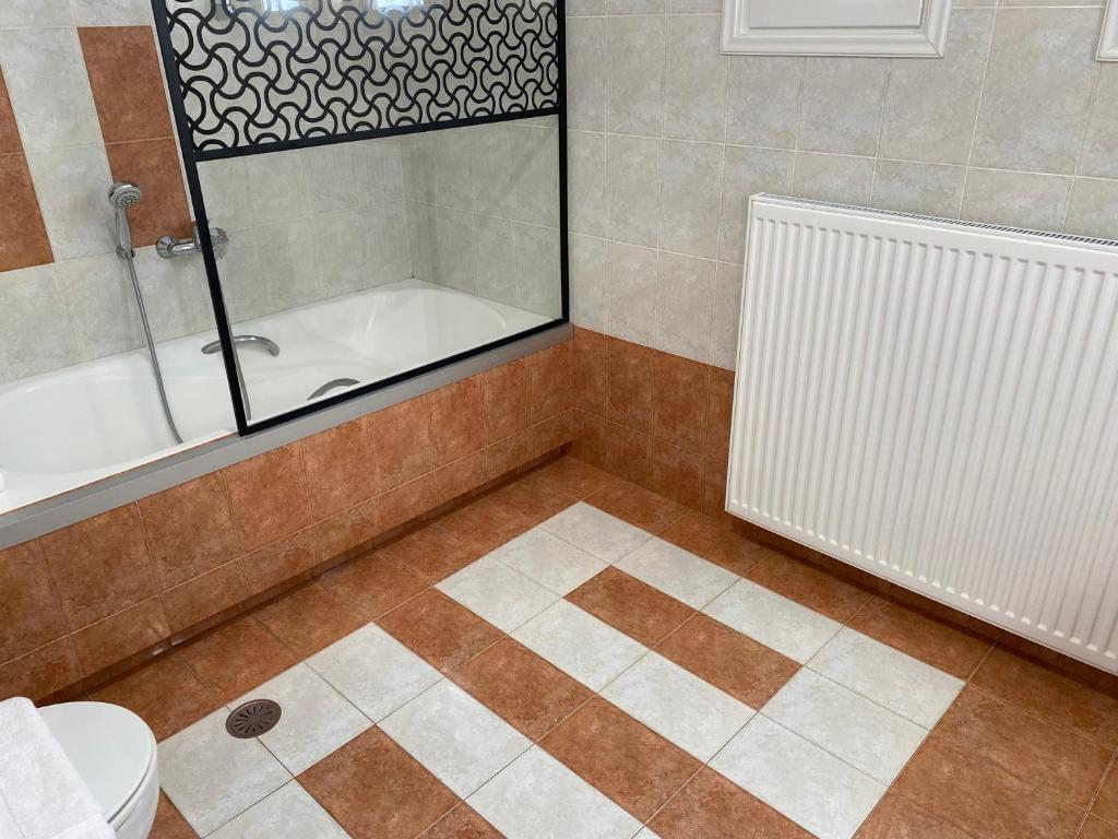 a bathroom with a shower and a tub and a toilet at PORTA HOME modern and hospitable in Naxos Chora