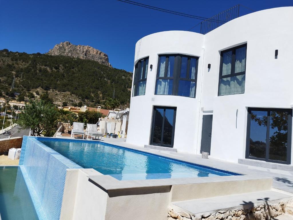 una villa con piscina con una montagna sullo sfondo di Modern luxury villa Paradise a Calpe
