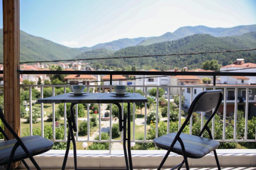 a table and chairs on a balcony with a view at ANASA in Stavros