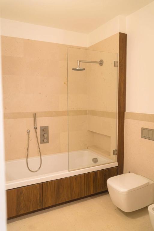 a bathroom with a tub and a toilet and a shower at Villa Romasi in Leuca