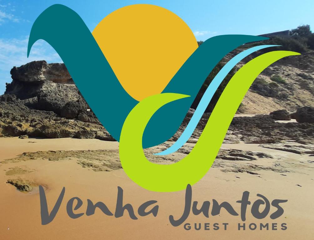 a sign for varla juhu guest homes on a beach at Venha Juntos Guest Homes in Miramar