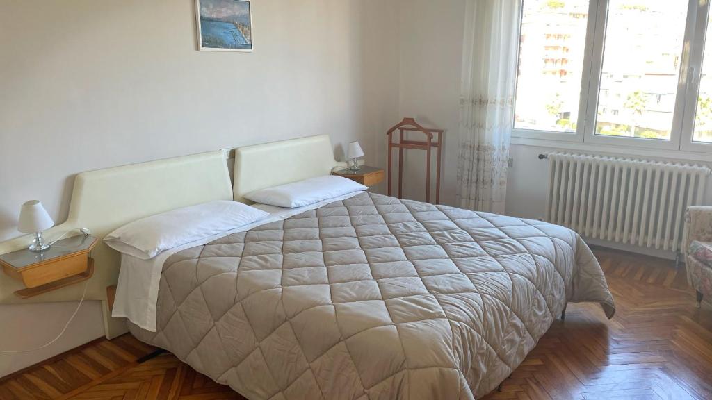 a bedroom with a large bed and a window at MAX and SEA parking in Sanremo