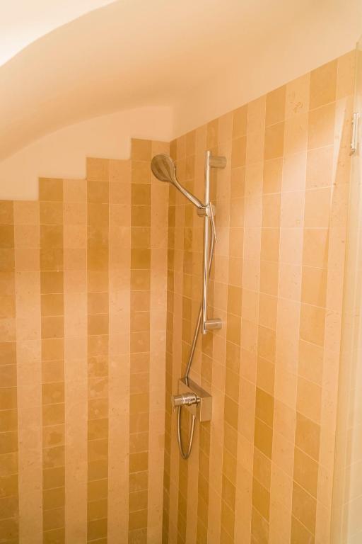 a shower with a shower head on a wall at Villa Romasi in Leuca