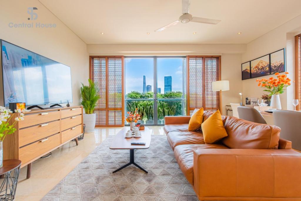 a living room with a couch and a large screen tv at Park view Avalon Apartment District 1 HCM City in Ho Chi Minh City