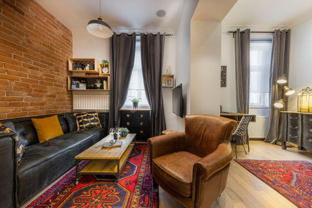 a living room with a couch and a brick wall at 3on7 Apartments in Zagreb
