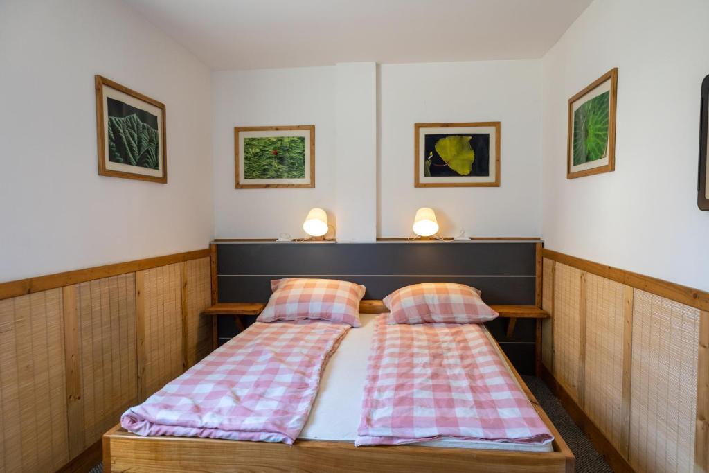 a bedroom with two beds with plaid pillows at Apartmani Papeš in Krapina