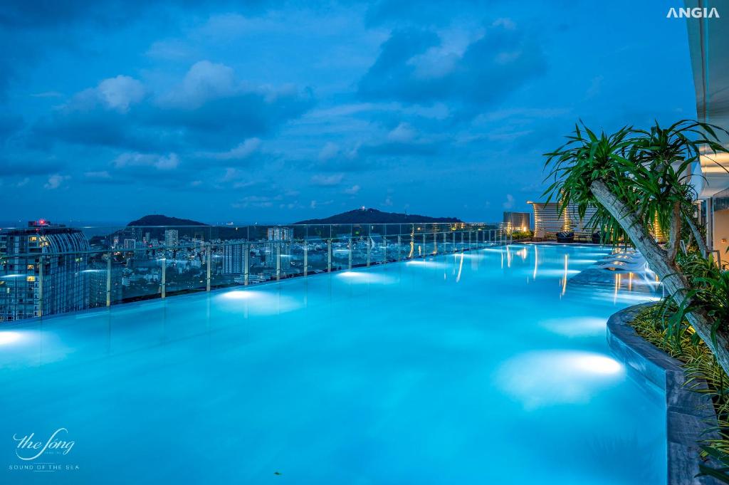 a swimming pool at night with a view at The Sóng Condotel in Vung Tau City - The Sóng Real Company in Vung Tau
