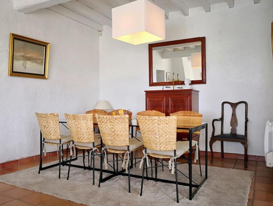 a dining room with a table with chairs and a mirror at Beautiful Sea View House in Vallauris