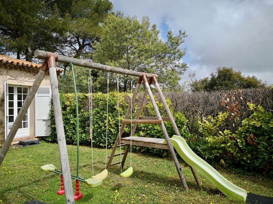 a playground with a swing in a yard at Beautiful Sea View House in Vallauris