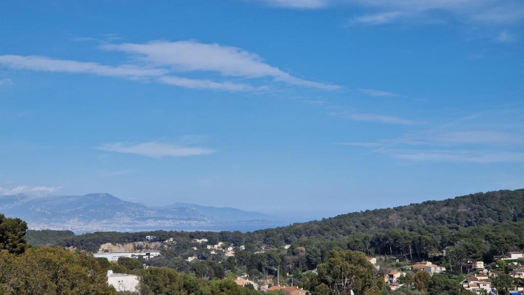 a view of a city from a hill with trees at Beautiful Sea View House in Vallauris