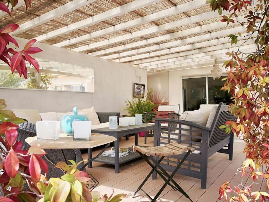 a patio with a table and chairs and a couch at Beautiful Sea View House in Vallauris