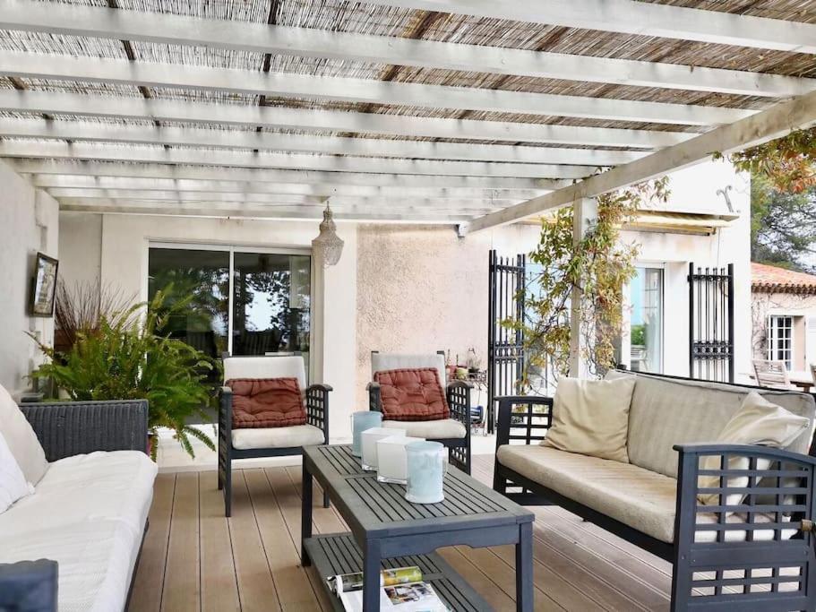 a patio with couches and a table and chairs at Beautiful Sea View House in Vallauris