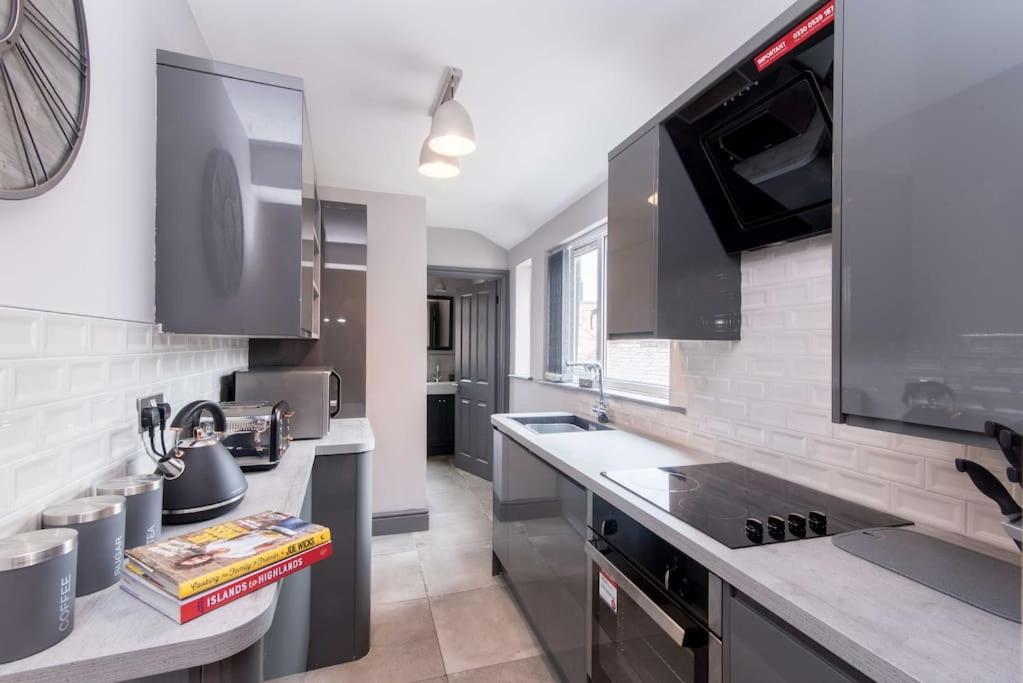 a kitchen with a sink and a counter top at Impressive Apartment in Derby in Derby