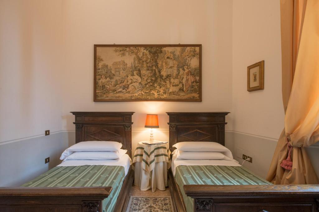 Postel nebo postele na pokoji v ubytování Palazzo Rotati