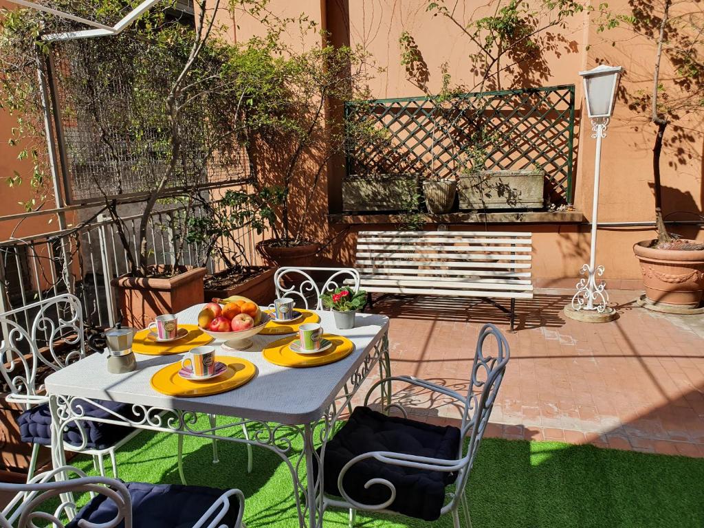 a table with a plate of fruit on a patio at Alma Vacation Apartment in the centre, big terrace in Milan