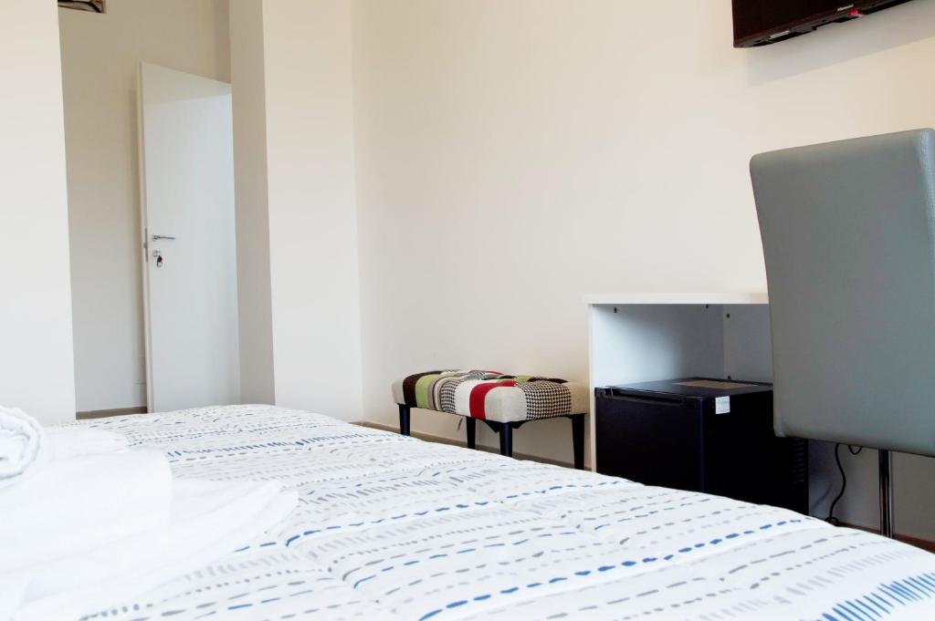 Postel nebo postele na pokoji v ubytování Minerva Rooms