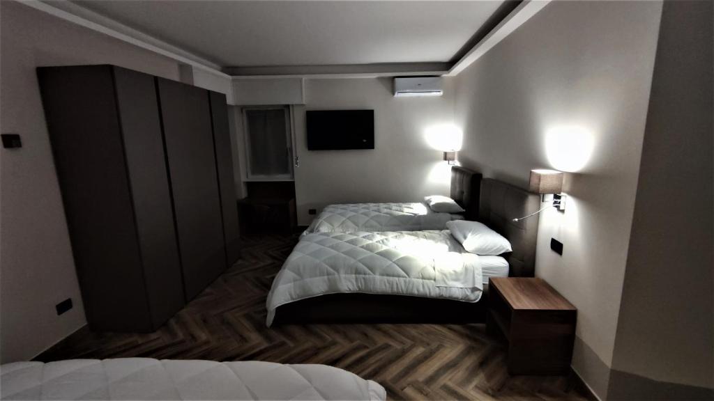 Postel nebo postele na pokoji v ubytování Hotel Emiliana