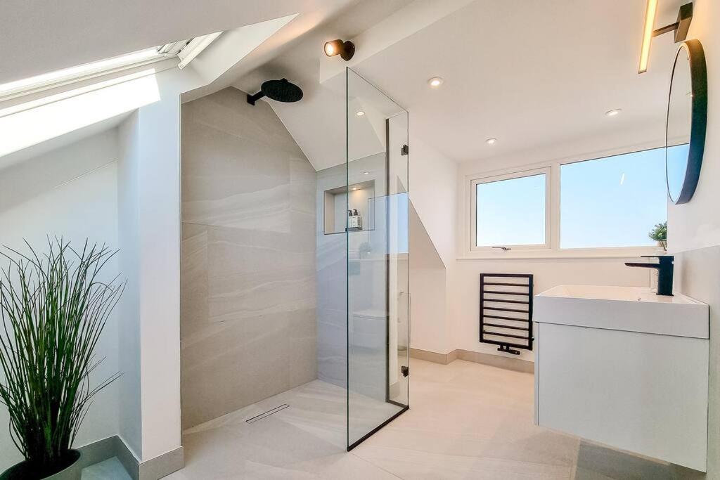 a bathroom with a glass shower and a sink at ScandicStay-Apartment Harrogate in Harrogate