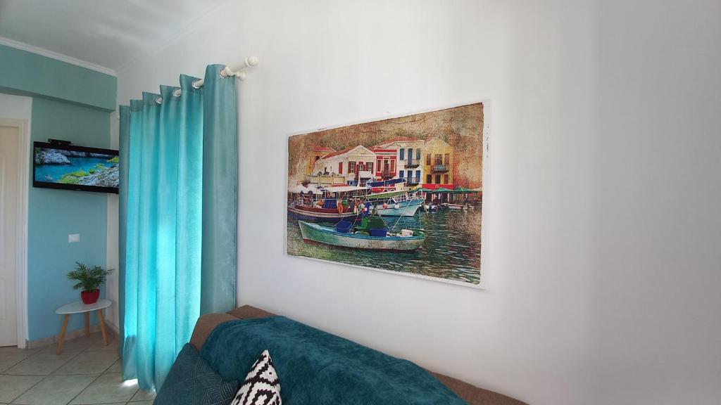 a painting of a boat hanging on a wall at AGIOS LEON Apartment 3 in Agios Leon