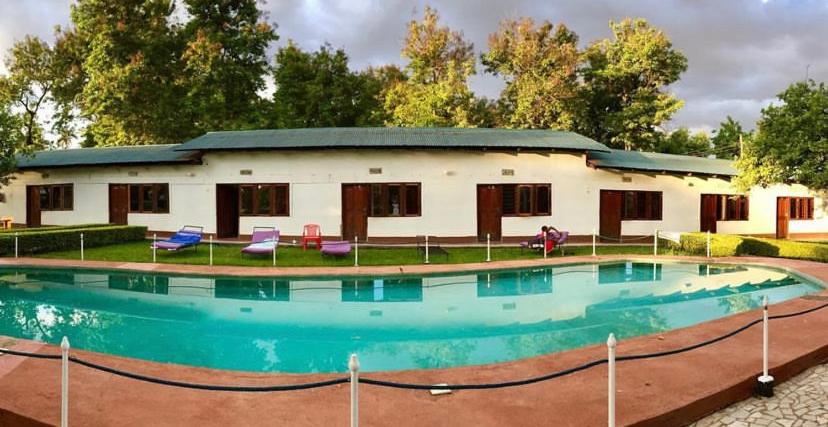 a house with a large pool in front of it at Fig Tree Lodge Camp in Mto wa Mbu