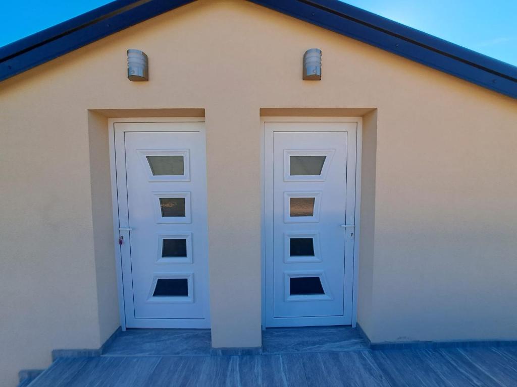 two doors on the side of a building at Apartments Sofie & Emily in Gornji Karin