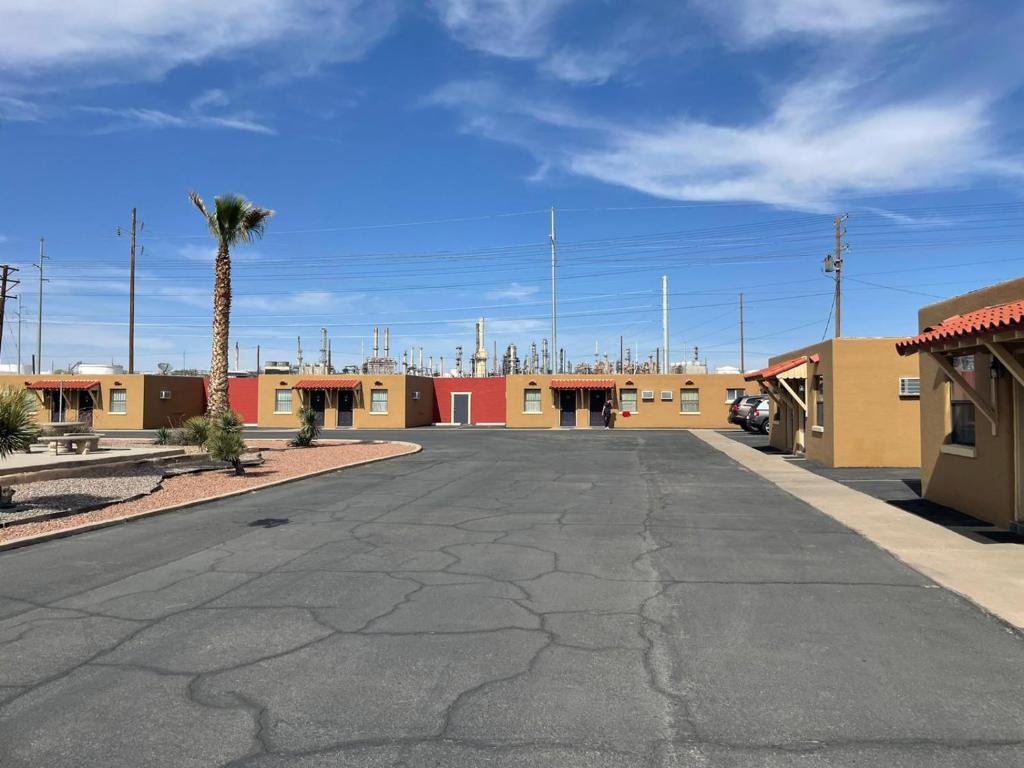 an empty parking lot in front of a motel at Sands Motel in El Paso