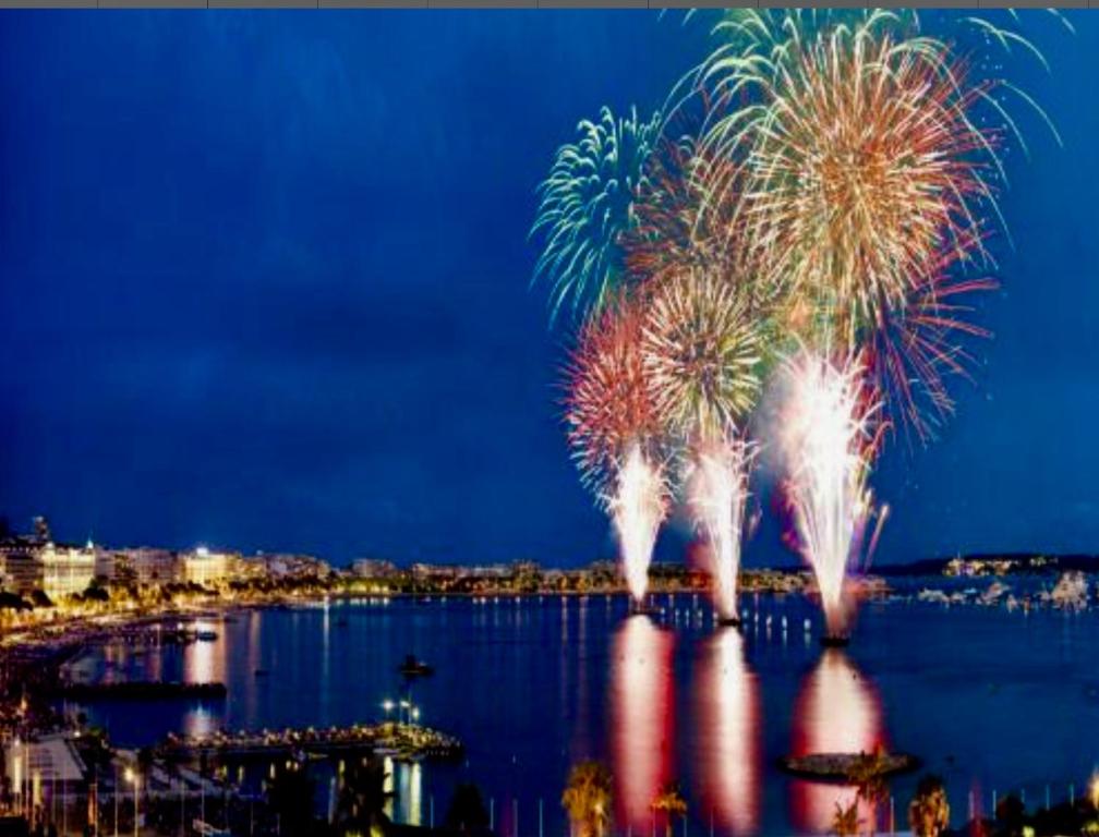 a fireworks display over a body of water at Croisette pearl in Cannes