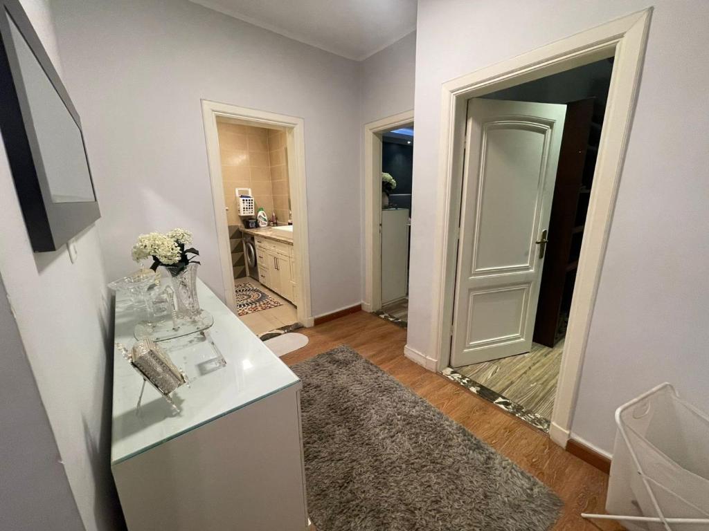 a bathroom with a mirror and a vase of flowers at Apartment for rent in Ramo 6 October in 6th Of October