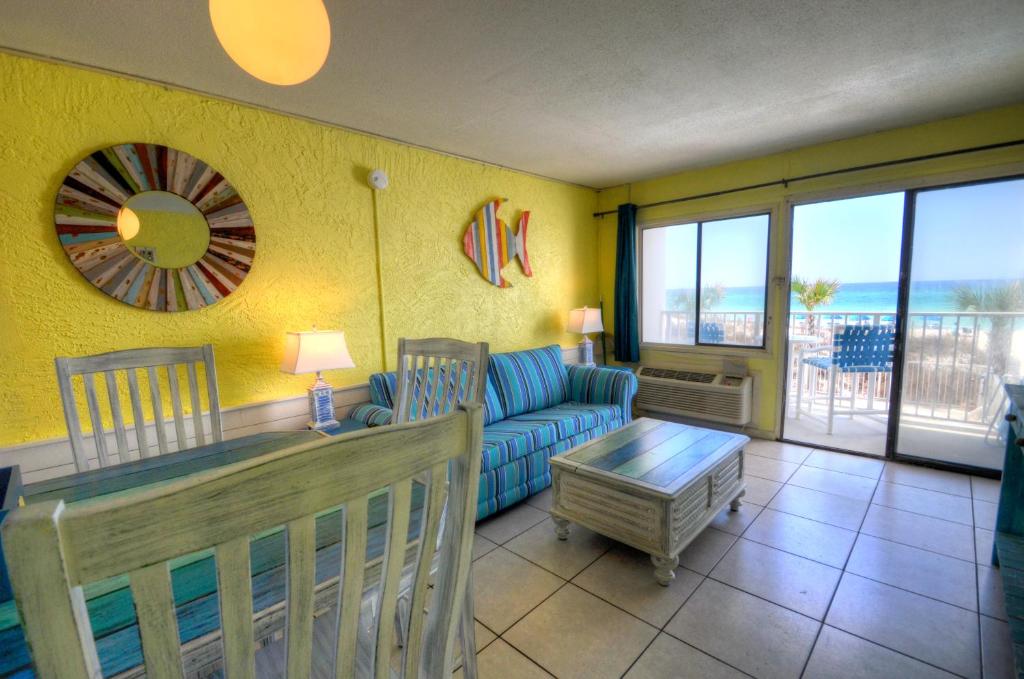 a living room with a couch and a table at Starfish Villa in Panama City Beach
