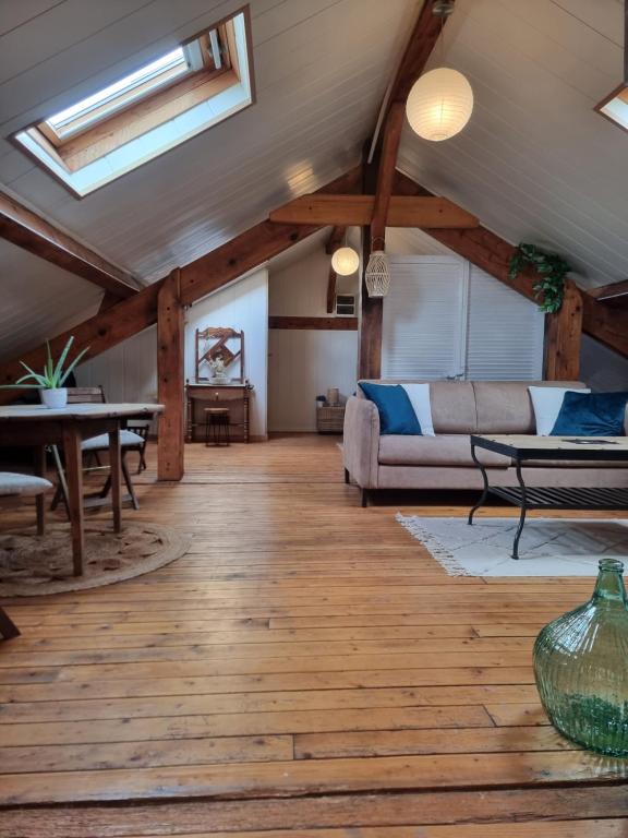 a living room with wooden floors and a ceiling with skylights at Quai 2 voie C 