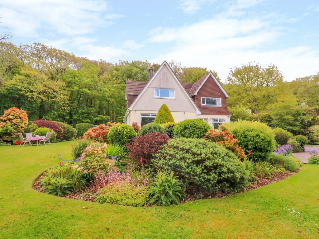 a house with a garden of colorful bushes at Trevow in Camborne