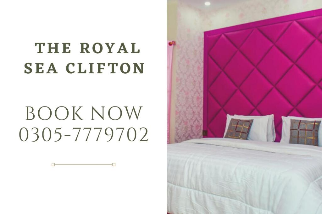 a bedroom with a pink headboard and a white bed at The Royal Sea Clifton in Karachi