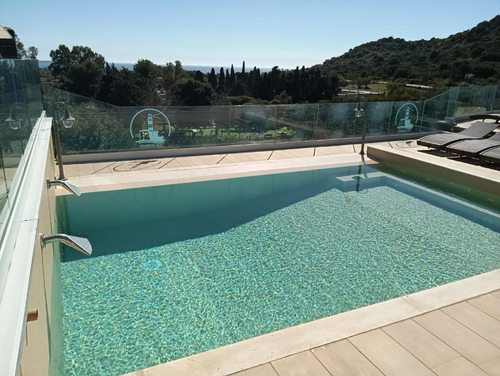 una piscina con vistas a la montaña en crabonaxa suites, en Villasimius