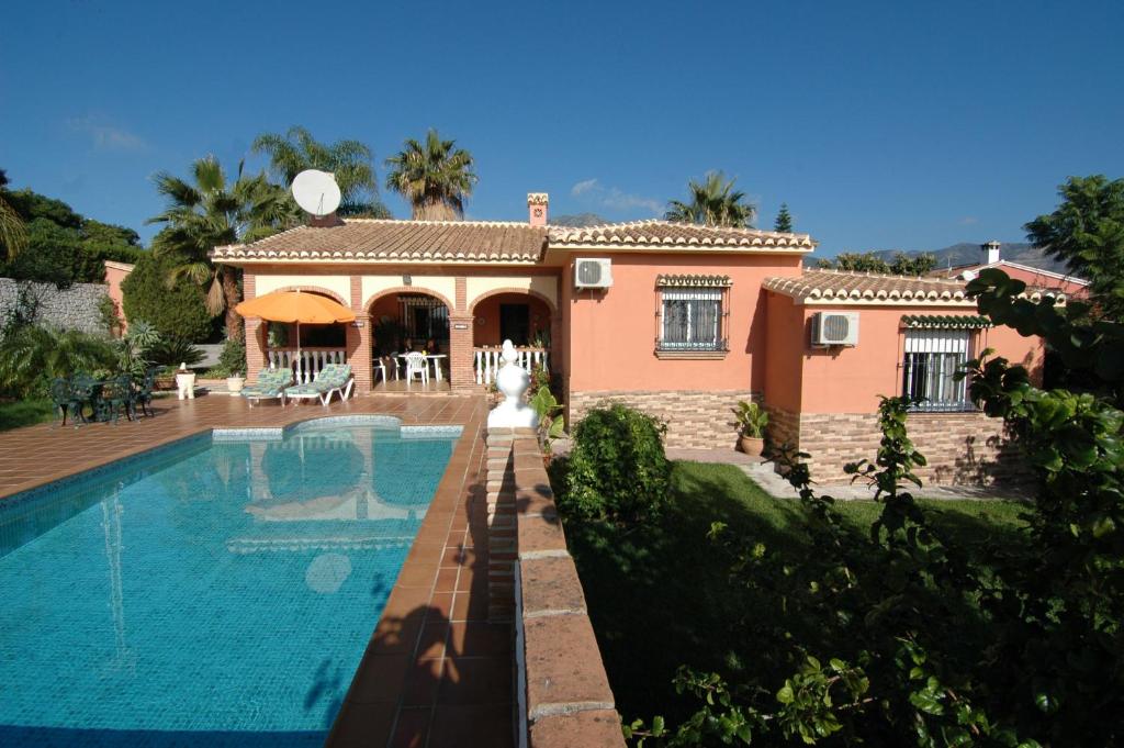 une maison avec une piscine en face de celle-ci dans l'établissement Villa La Palma, à Mijas