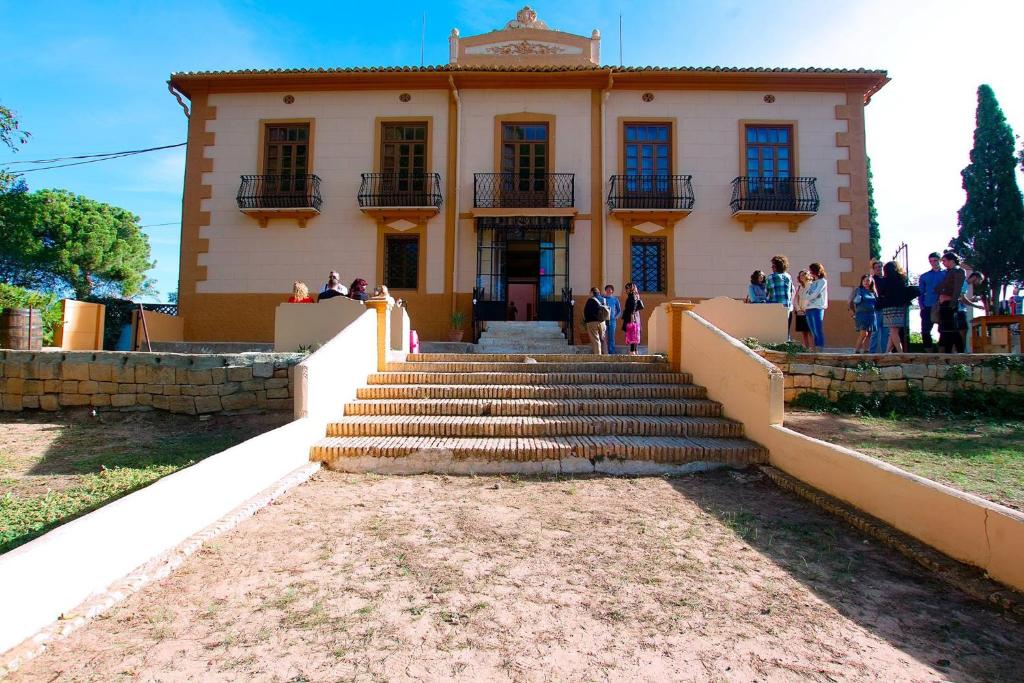 a group of people walking up the stairs to a building at HOTEL BODEGA VERA DE ESTENAS in Utiel