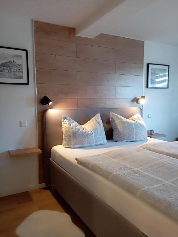 a bedroom with a large bed with two pillows at Kleines Moselchalet in Cochem