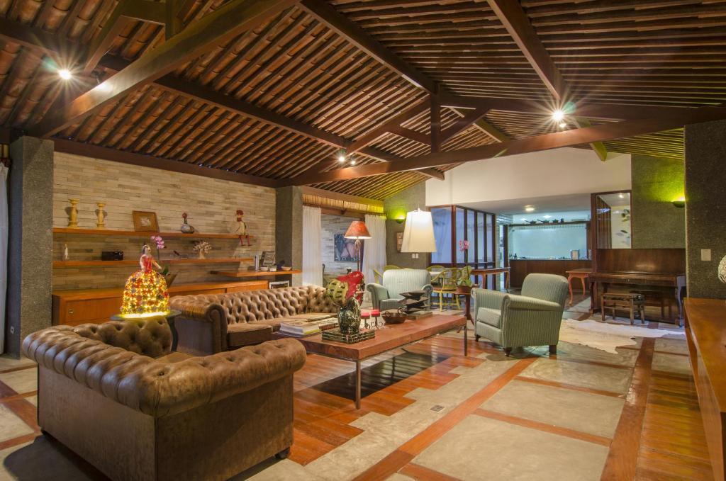 a living room with a couch and a table at Oasis Hotel Spa in Gravatá