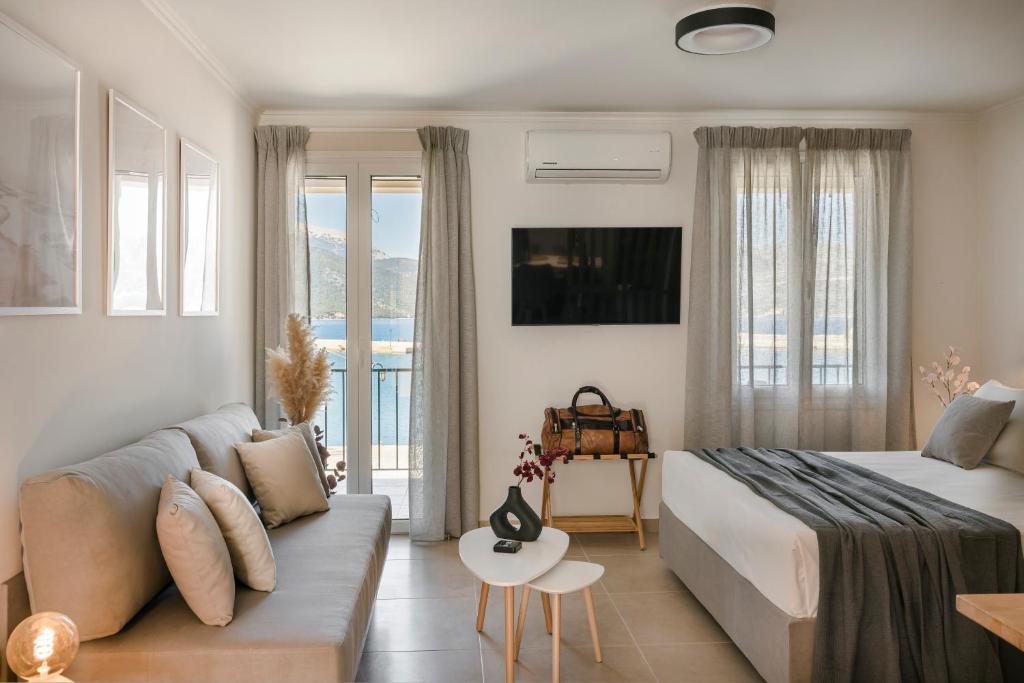 a hotel room with a bed and a couch at Klio Seafront House, Sami Kefalonia in Sami