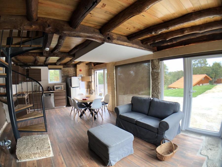 a living room with a couch and a table at Vila Espigueiro I in Bustelo