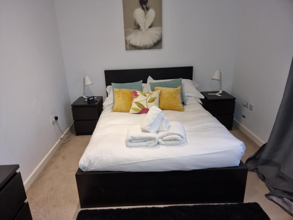a bedroom with a bed with towels on it at Heritage Place by Select SA in Reading