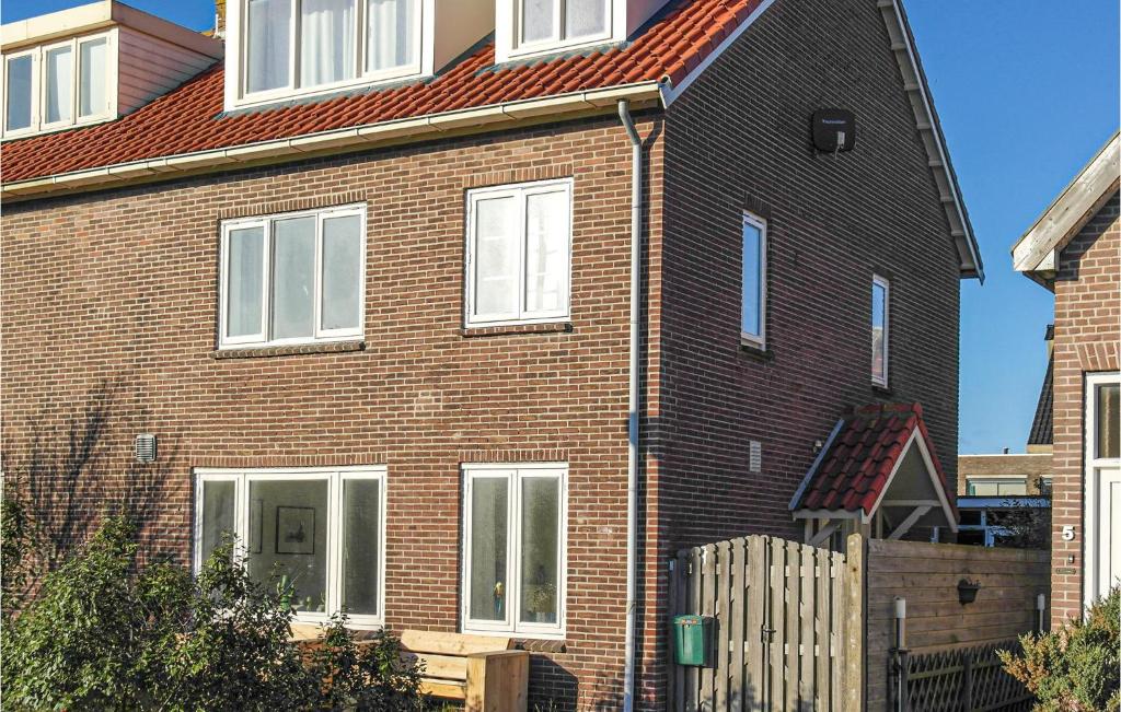 a large brick house with a red roof at Nautilus 1 in Bergen aan Zee