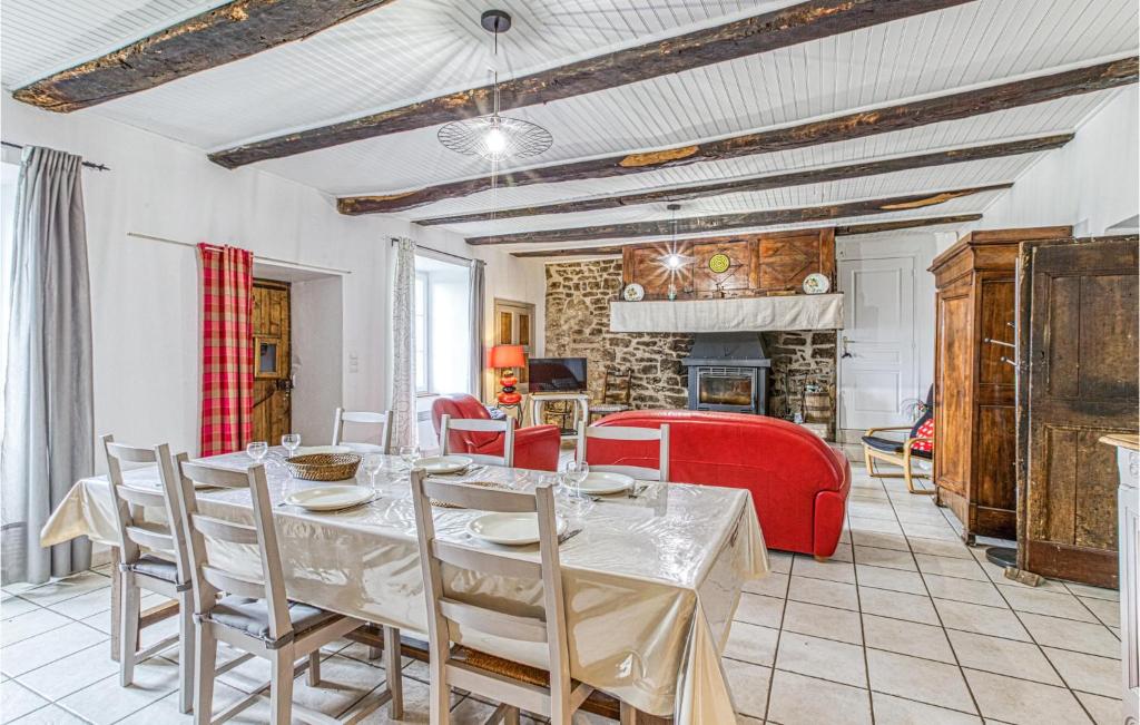 a dining room with a table and red chairs at Gorgeous Home In Pierrefiche With House A Panoramic View in Pierrefiche