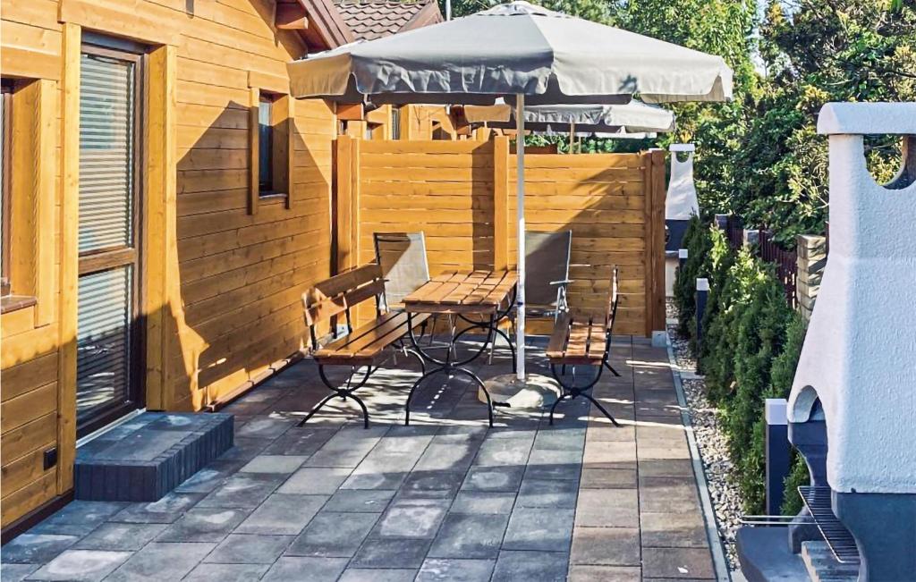 a patio with a table and chairs and an umbrella at Nice Home In Sianozety With Kitchen in Sianozety