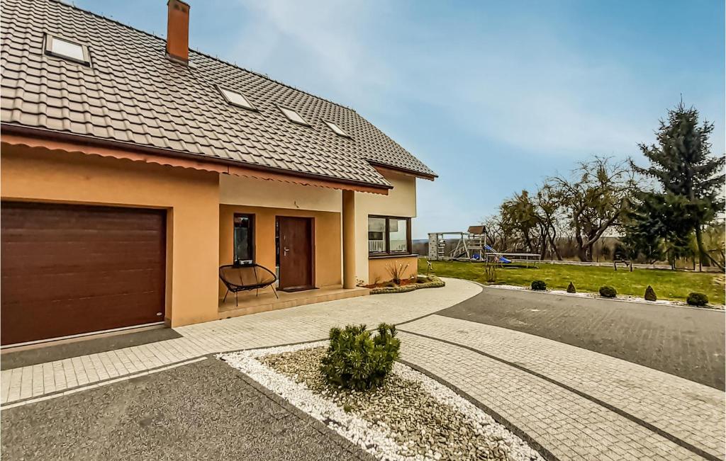 a house with a garage and a driveway at Awesome Home In Mragowo With Lake View in Mrągowo