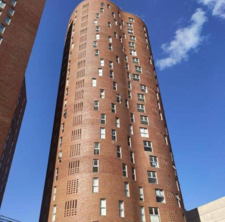 a tall red brick building with many windows at TORRES H in Cordoba