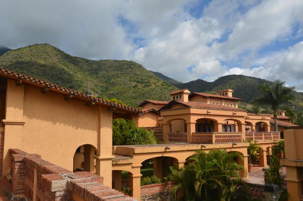 a large house with mountains in the background at Villas Danza del Sol in Ajijic