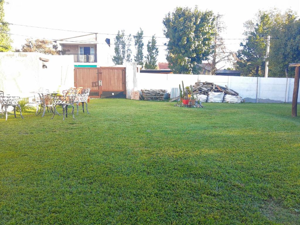 a yard with chairs and tables and a fence at Doña Vanina in Villa Larca