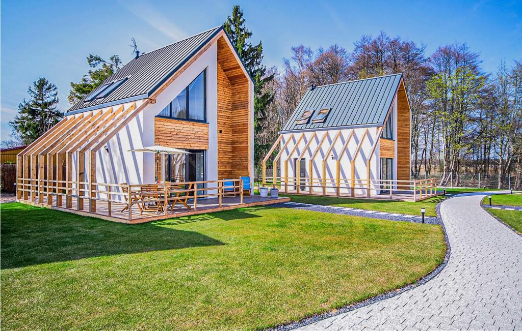 a large wooden house with a metal roof at Amazing Home In Nowecin With Kitchen in Nowecin
