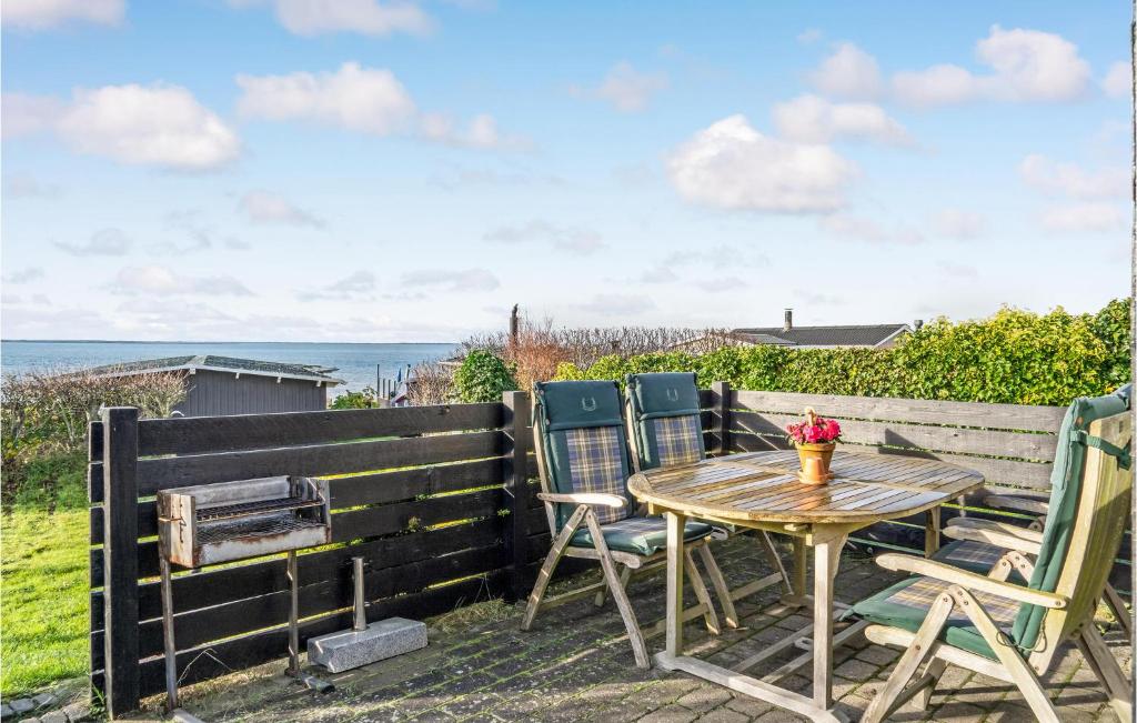 a table and chairs on a patio with the ocean at Amazing Home In Esbjerg V With House Sea View in Esbjerg