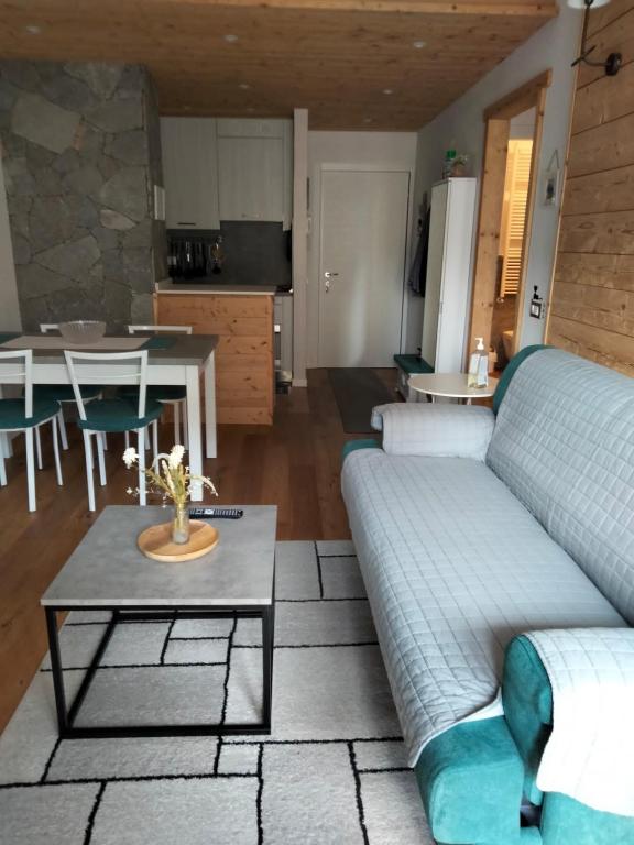 uma sala de estar com um sofá e uma mesa em Condominio Baradello em Aprica